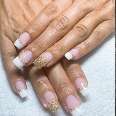 Pink and white French tips with gold glitter accents